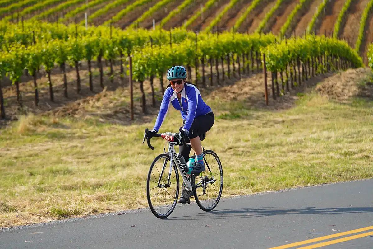 Single cyclist by vineyard