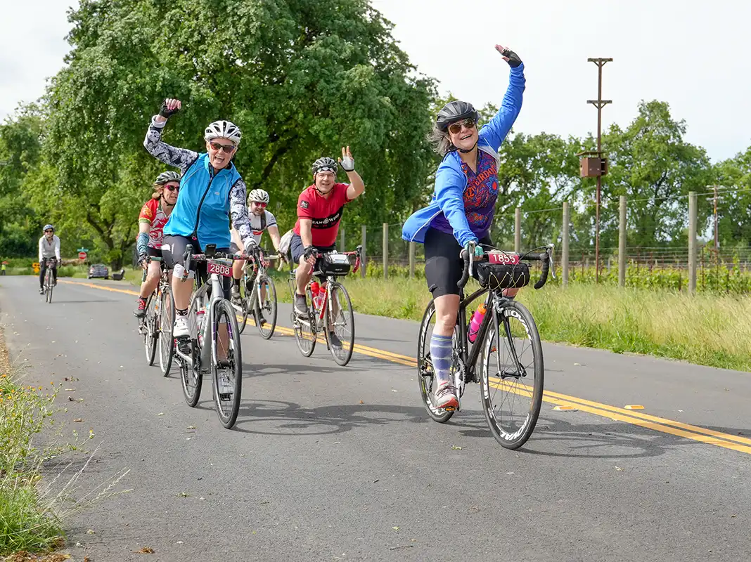 Cyclists on the road waving